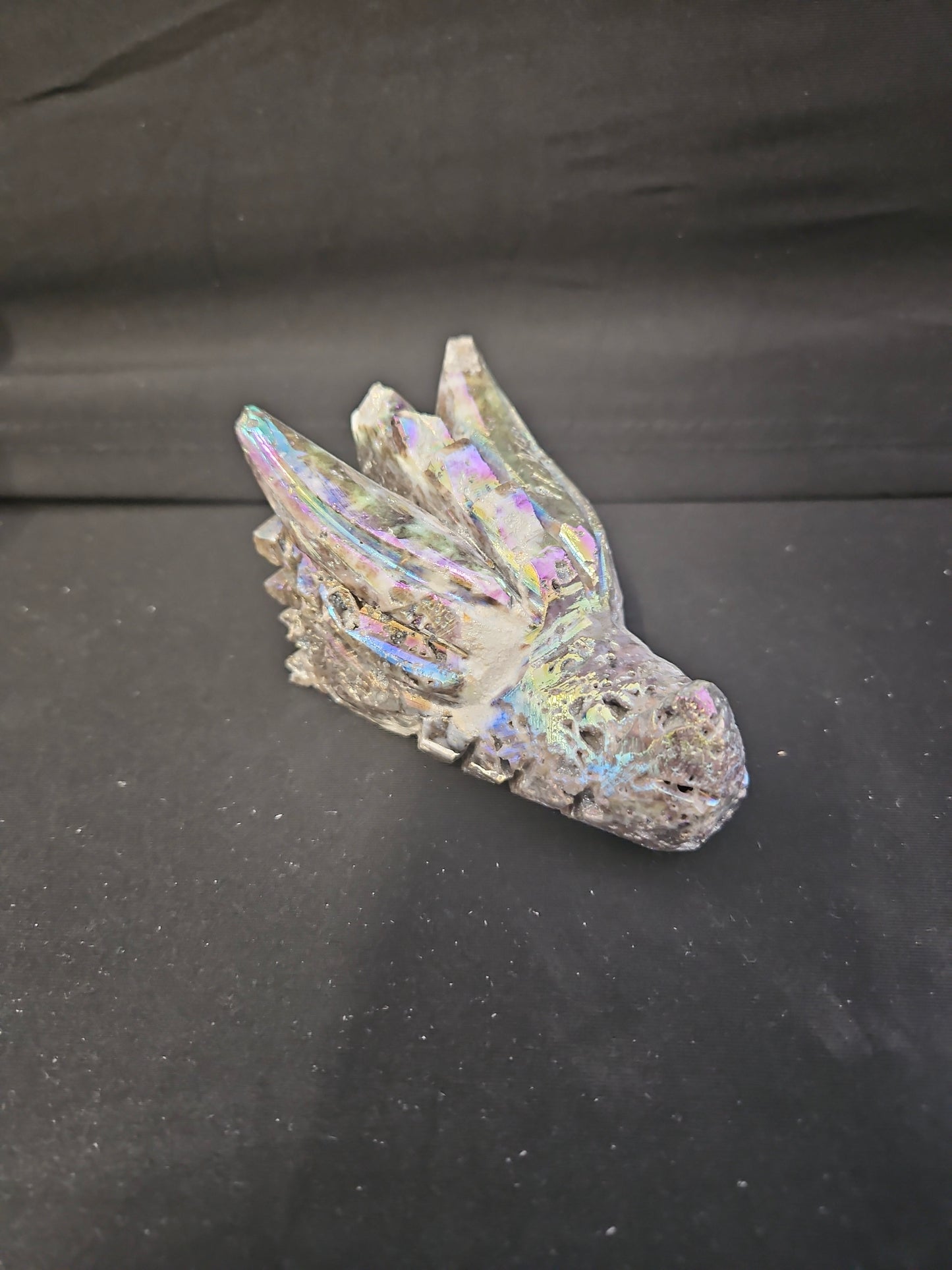 Iridescent Dragon Skull figurine on a black background