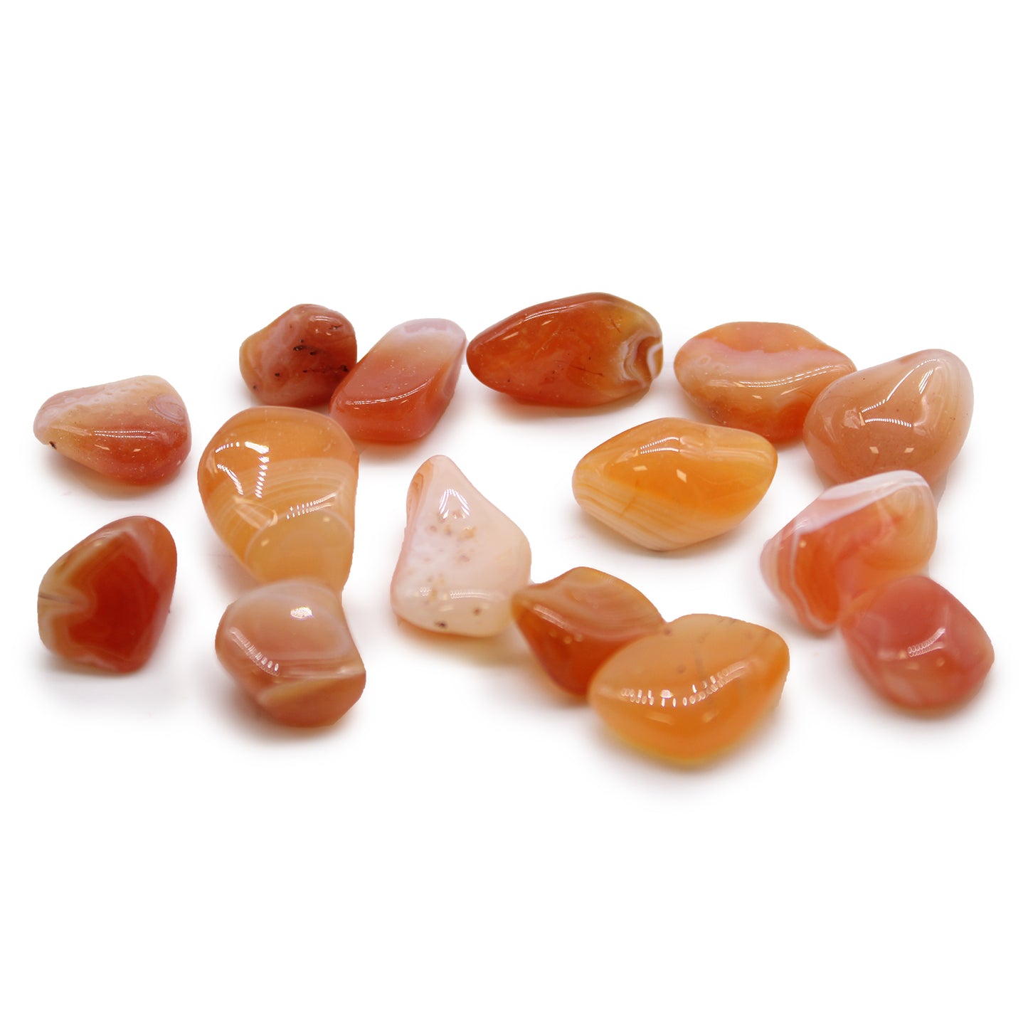 Collection of polished Carnelian stones on a white background
