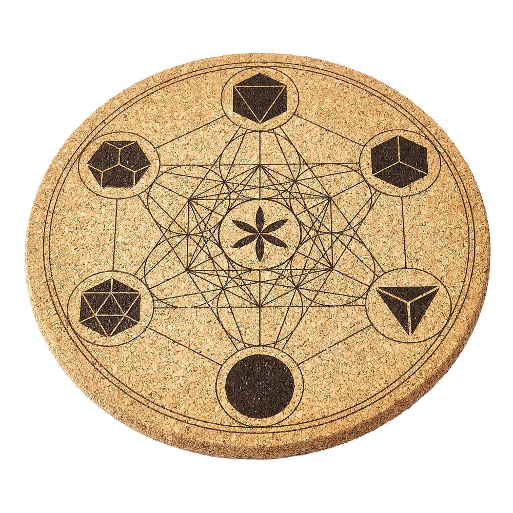 Round cork crystal mat with geometric design on a white background