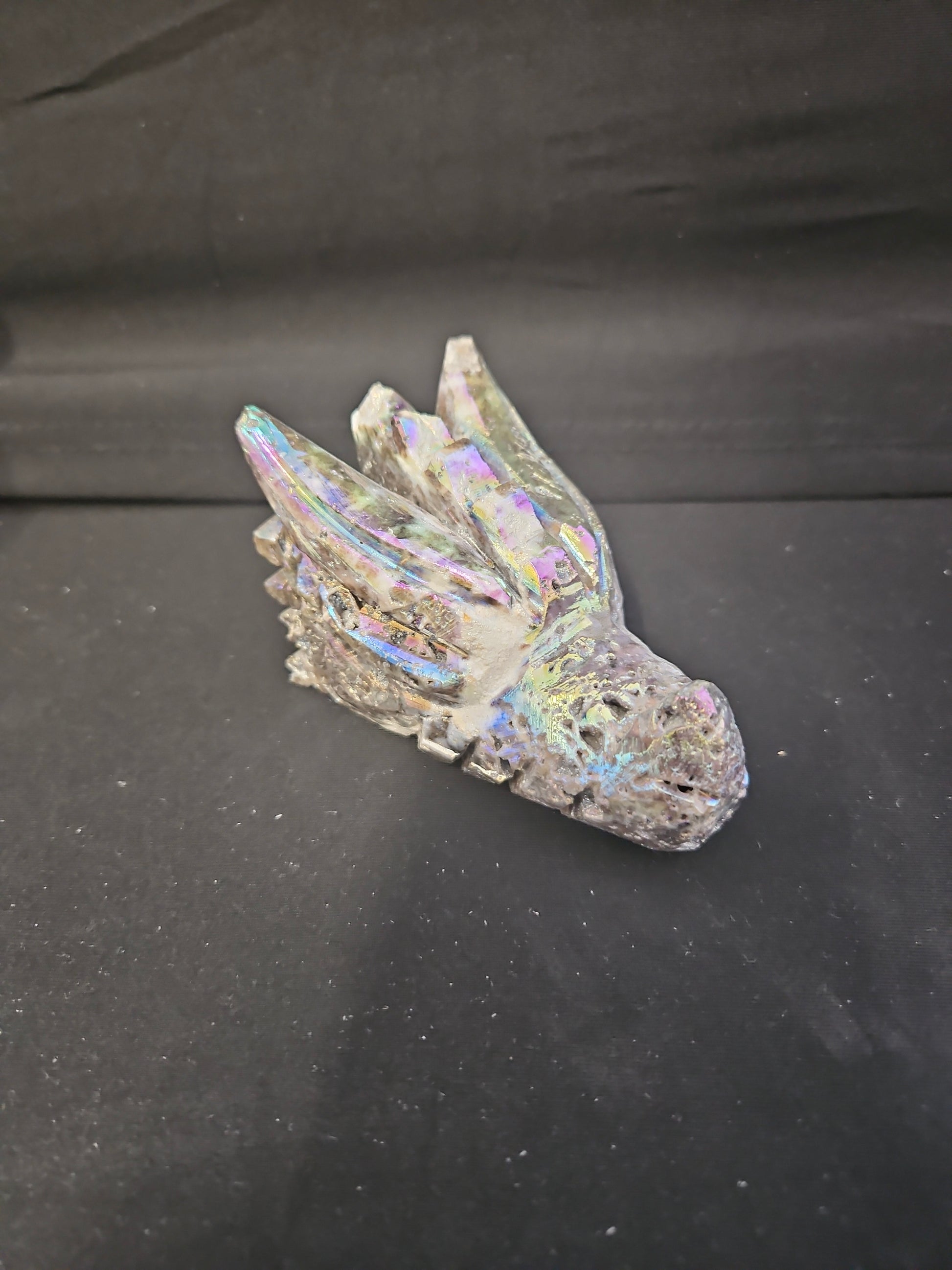 Iridescent Dragon Skull figurine on a black background