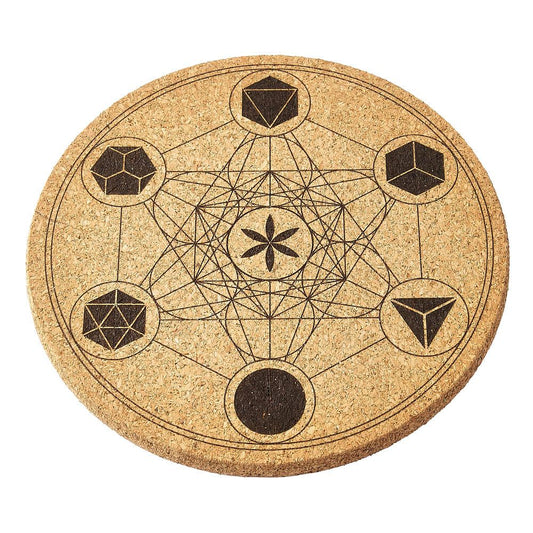 Round cork crystal mat with geometric design on a white background