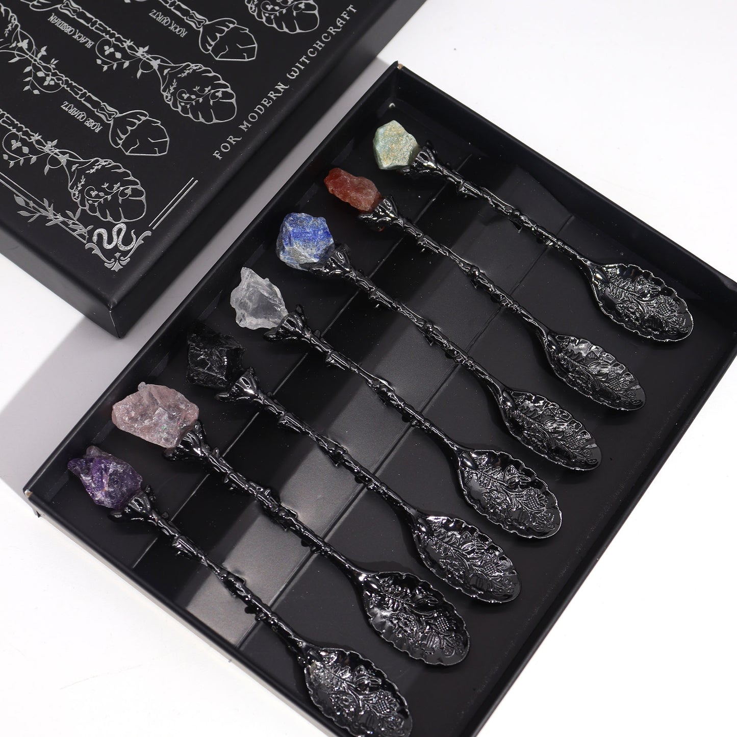 Set of decorative spoons with crystals in a black box